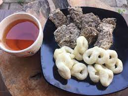 Green double couch with wooden legs