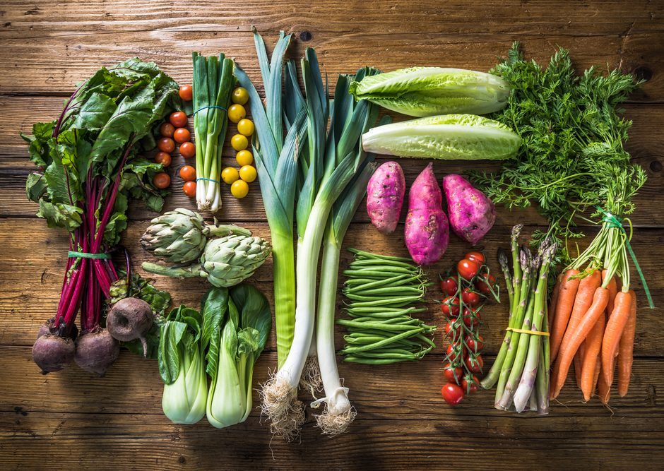 Green double couch with wooden legs
